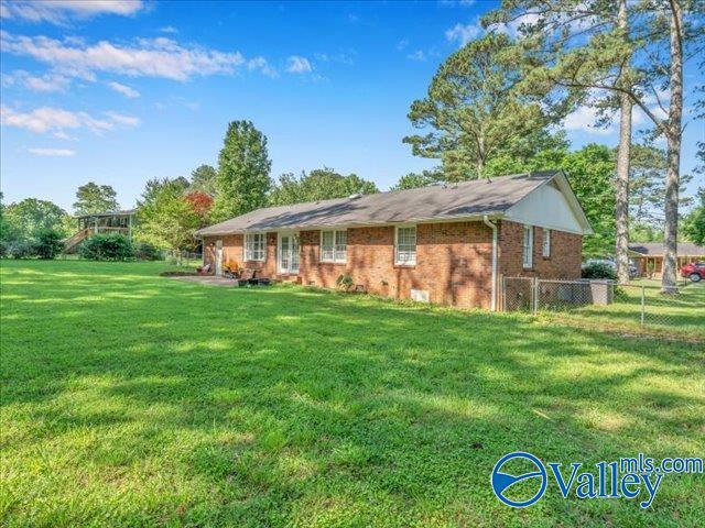 back of house featuring brick siding