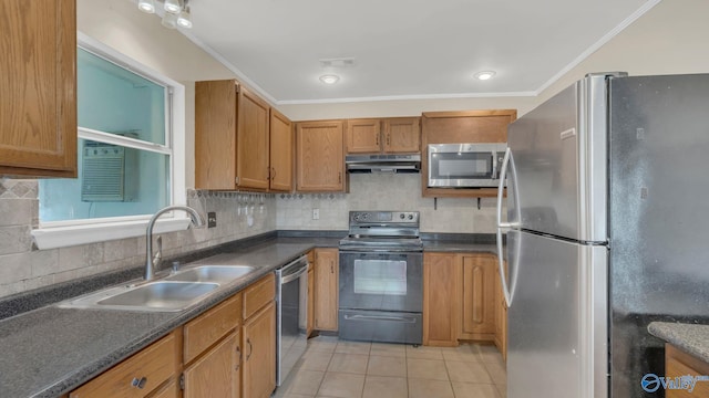 121 Oakline Dr, Madison, AL 35757 - kitchen featuring appliances with stainless steel finishes, under cabinet range hood, a sink, dark countertops, and light tile patterned floors