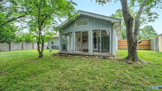 121 Oakline Dr, Madison, AL 35757 - back of property featuring board and batten siding, a sunroom, and central AC
