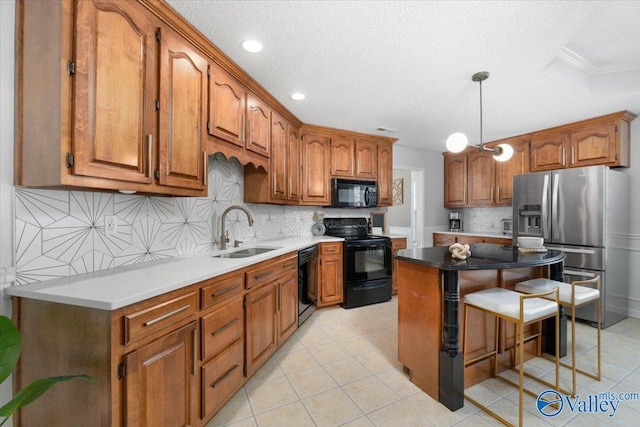 kitchen with tasteful backsplash, sink, a center island, light tile patterned floors, and black appliances