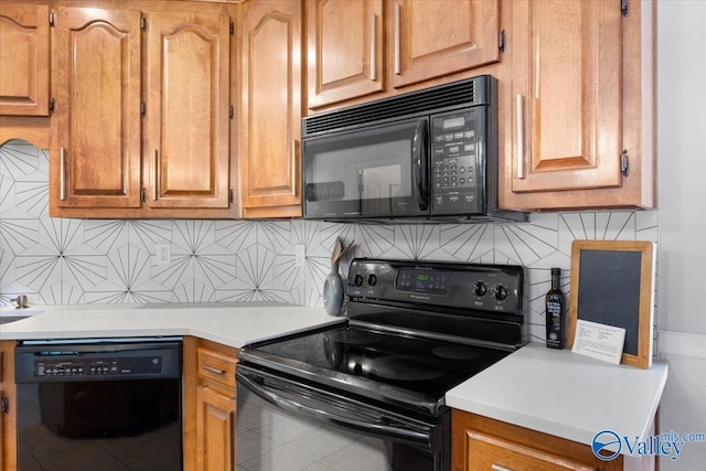 kitchen featuring tasteful backsplash, tile patterned flooring, and black appliances