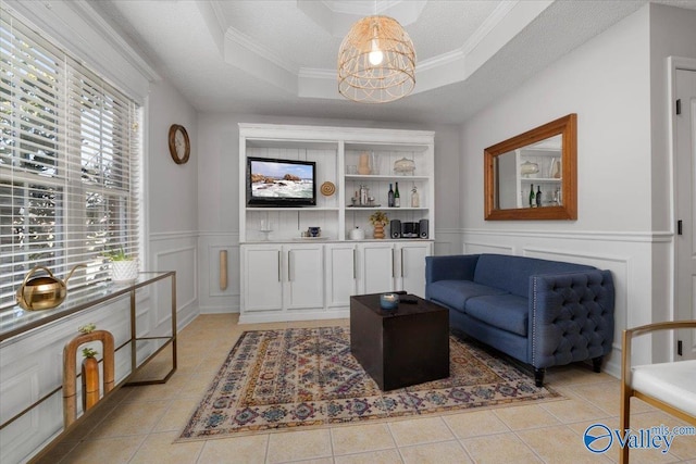 tiled living room featuring crown molding, a tray ceiling, and a textured ceiling