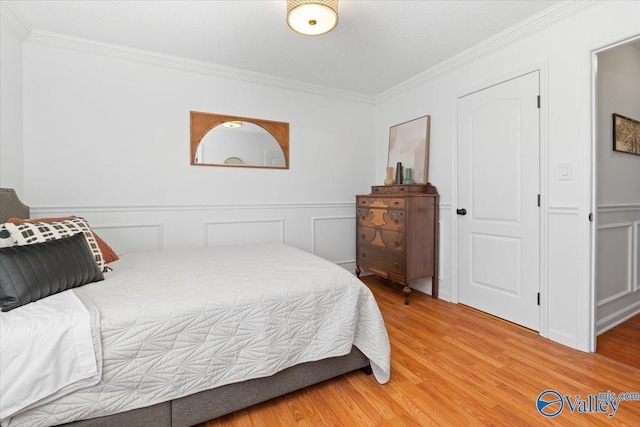 bedroom with hardwood / wood-style flooring and ornamental molding