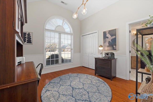 office with hardwood / wood-style flooring and lofted ceiling