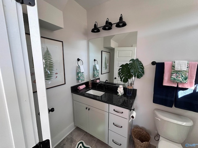 bathroom with tile patterned flooring, vanity, and toilet