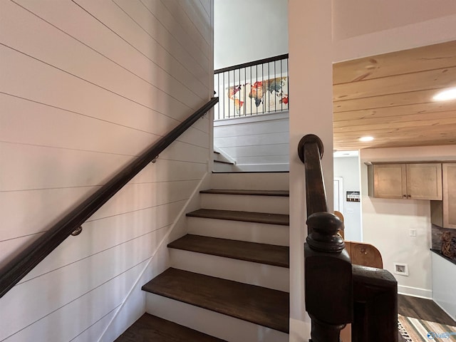 stairs with wooden ceiling and hardwood / wood-style flooring