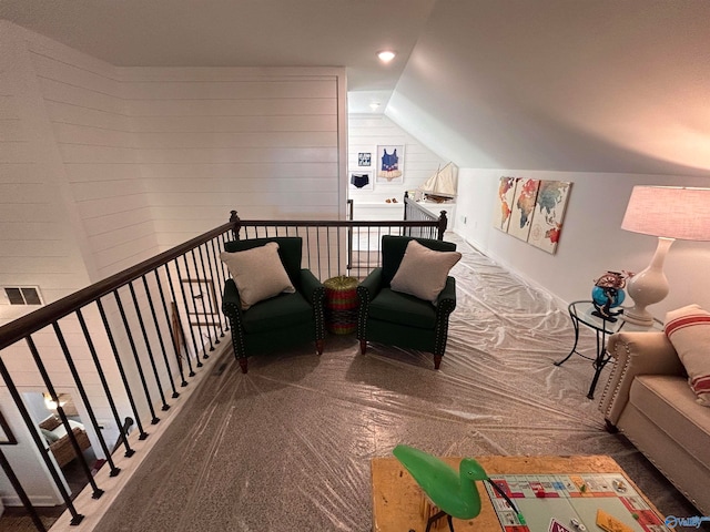 interior space featuring carpet flooring and lofted ceiling