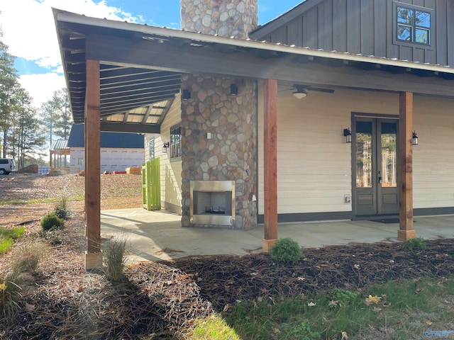 view of patio / terrace with ceiling fan and an outdoor stone fireplace