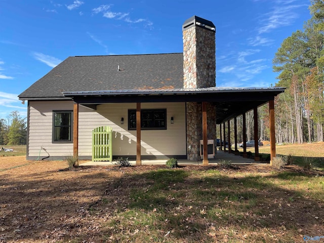 rear view of property featuring a patio area and a lawn