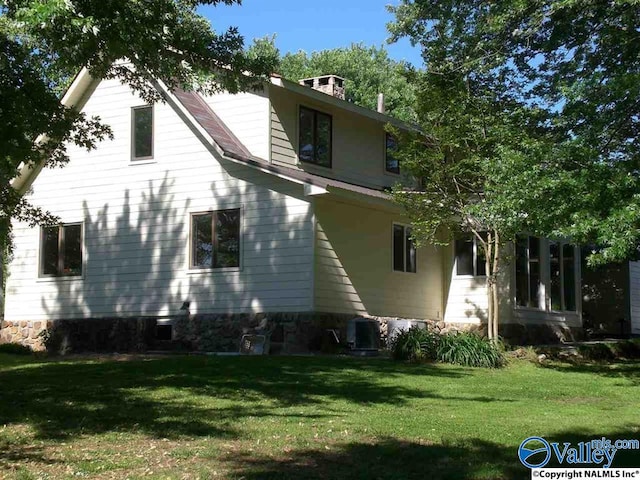 view of home's exterior featuring a yard and central air condition unit