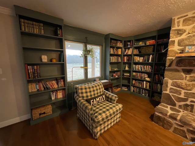 living area featuring hardwood / wood-style flooring and a textured ceiling