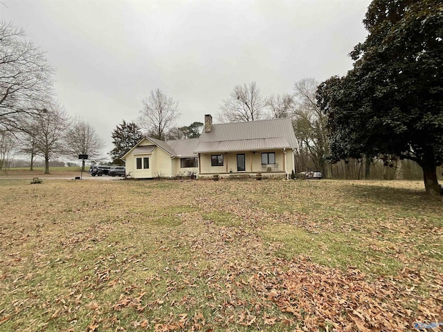 single story home with covered porch and a front lawn