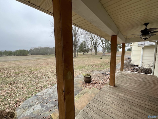 wooden deck featuring a rural view and ceiling fan