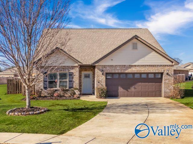 view of front of home with a garage and a front lawn