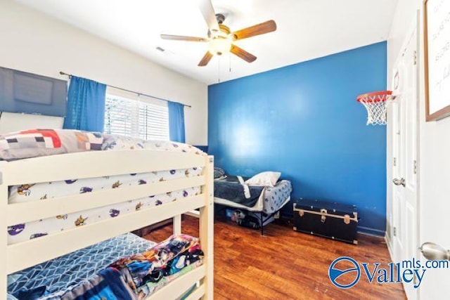 bedroom with hardwood / wood-style floors and ceiling fan