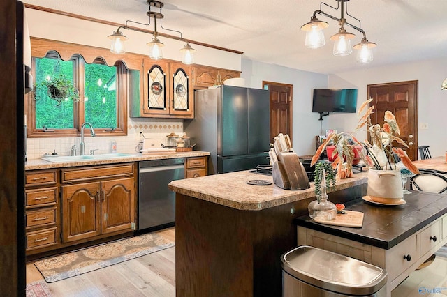 3103 Burningtree Mountain Rd, Decatur, AL 35603 - kitchen featuring dishwasher, freestanding refrigerator, a sink, light wood-style flooring, and light countertops