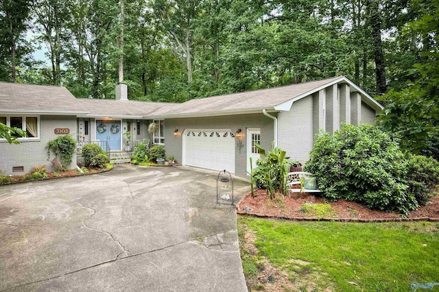 3103 Burningtree Mountain Rd, Decatur, AL 35603 - view of front of home featuring a garage, brick siding, driveway, a chimney, and a shingled roof