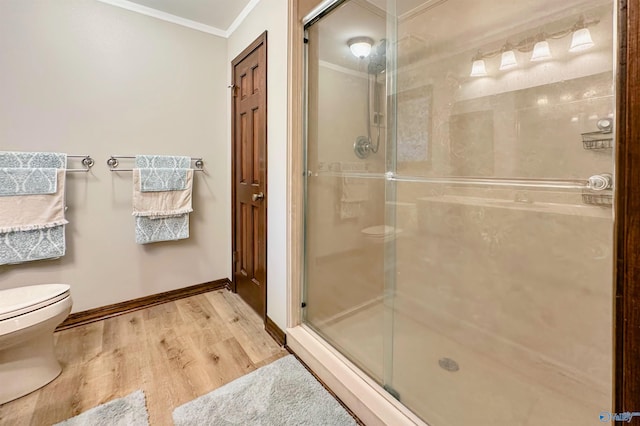 3103 Burningtree Mountain Rd, Decatur, AL 35603 - full bathroom with ornamental molding, toilet, a stall shower, wood finished floors, and baseboards