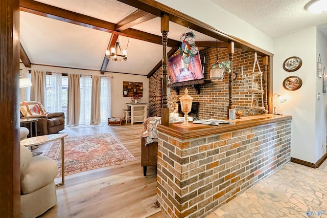 3103 Burningtree Mountain Rd, Decatur, AL 35603 - living room featuring bar, brick wall, a textured ceiling, baseboards, and wood finished floors