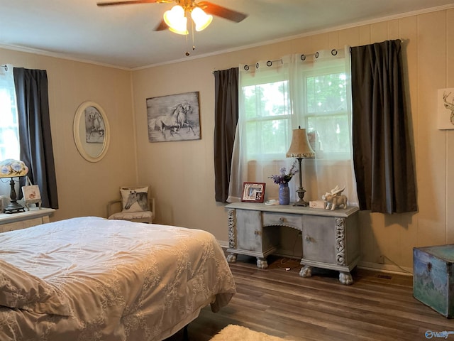 bedroom featuring ornamental molding, ceiling fan, and wood finished floors