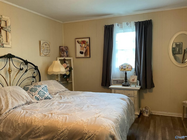 bedroom featuring baseboards, ornamental molding, and wood finished floors