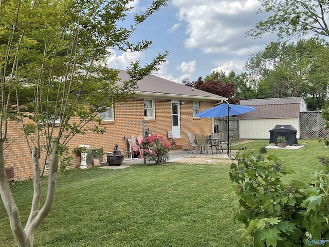 back of property with brick siding, a yard, and metal roof