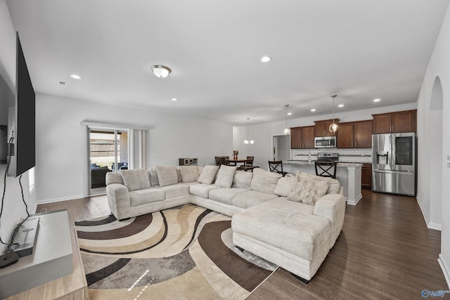 living area with recessed lighting, baseboards, and dark wood-type flooring