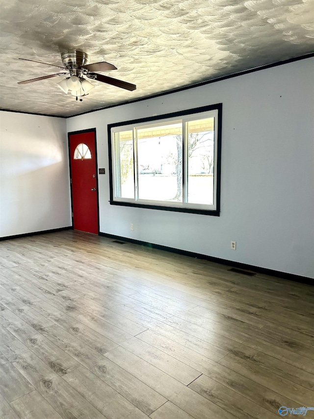 entryway featuring wood-type flooring, a textured ceiling, and ceiling fan