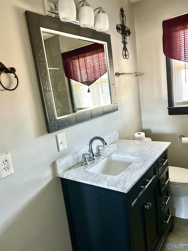 bathroom featuring vanity and toilet