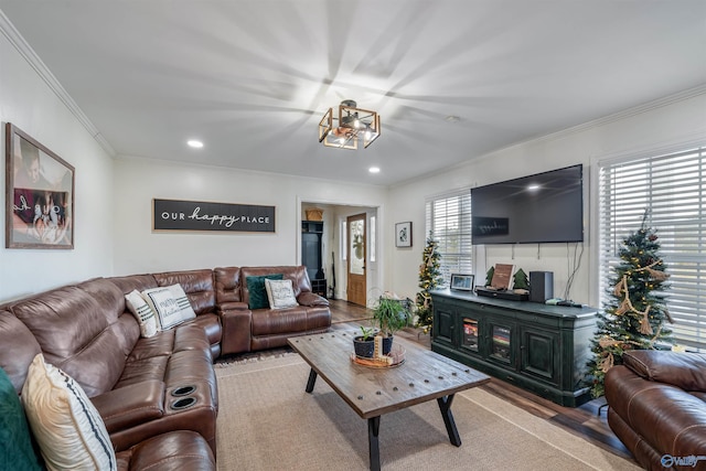 living room with light hardwood / wood-style flooring and crown molding