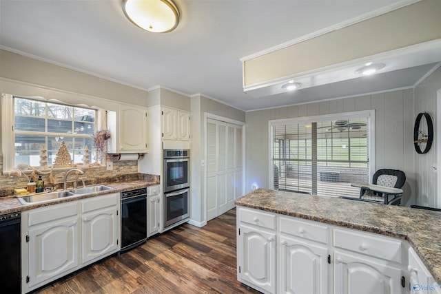 kitchen with crown molding, dishwasher, and white cabinets