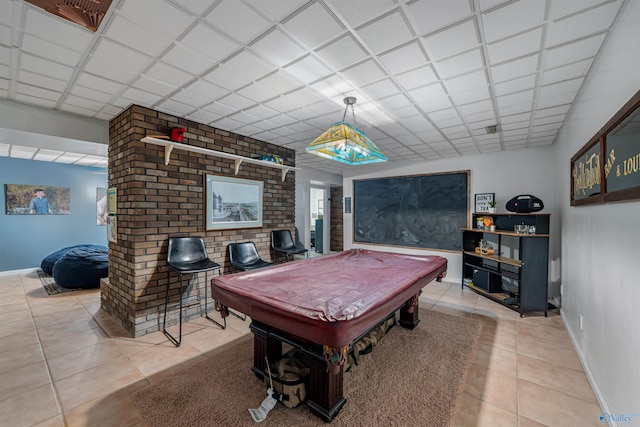 game room featuring a paneled ceiling, light tile patterned floors, and billiards