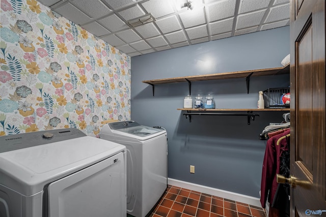 washroom with washing machine and dryer and dark tile patterned floors