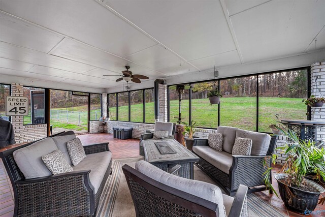 sunroom / solarium featuring ceiling fan and plenty of natural light