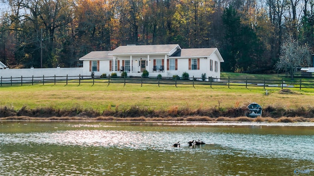 view of front facade with a water view and a front yard