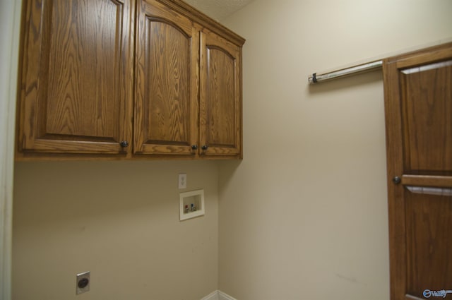 clothes washing area with hookup for a washing machine, cabinet space, and hookup for an electric dryer