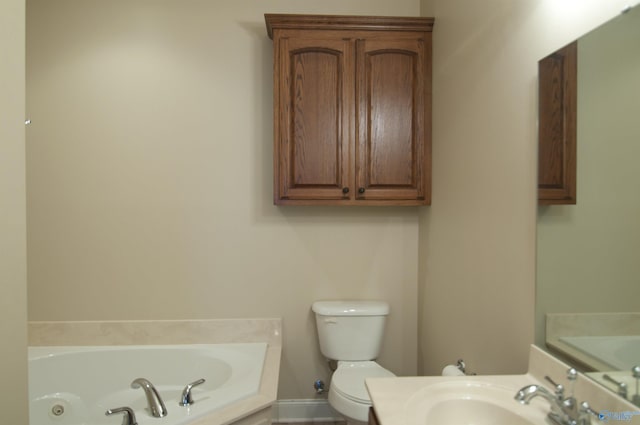 bathroom with a whirlpool tub, toilet, and a sink