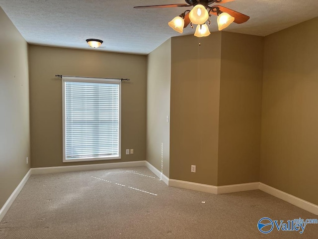 unfurnished room with ceiling fan, baseboards, a textured ceiling, and carpet flooring