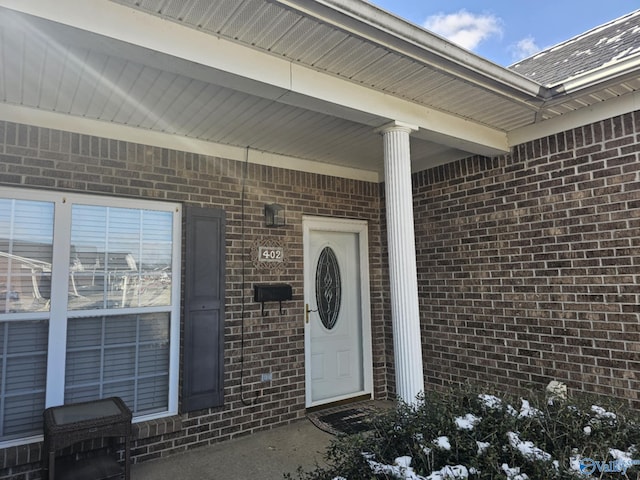 property entrance with brick siding