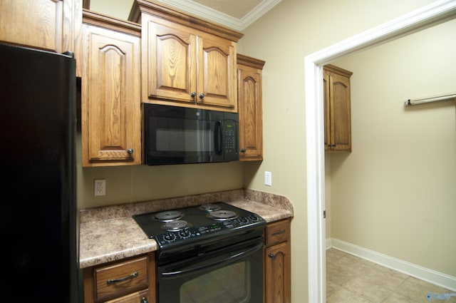 kitchen featuring black appliances, baseboards, brown cabinetry, and crown molding