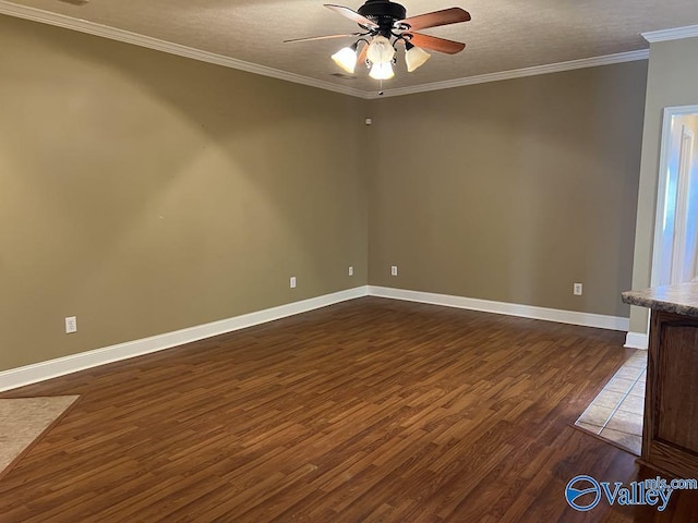 spare room with baseboards, dark wood-style floors, ceiling fan, a textured ceiling, and crown molding