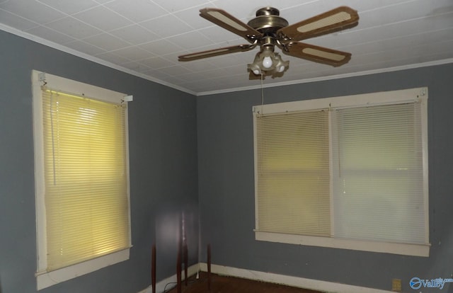 unfurnished room featuring ceiling fan, ornamental molding, and baseboards