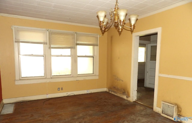 spare room with a healthy amount of sunlight, visible vents, ornamental molding, and a chandelier