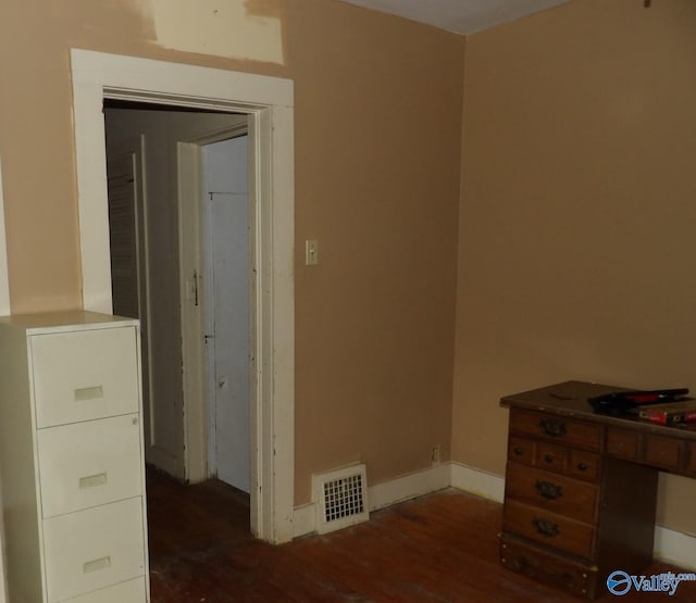 unfurnished bedroom with visible vents, baseboards, and wood finished floors