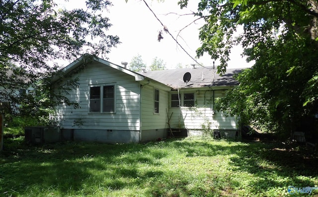 view of property exterior with crawl space and a lawn