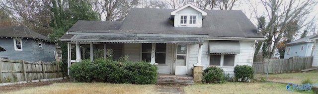 view of front of home with fence and a porch