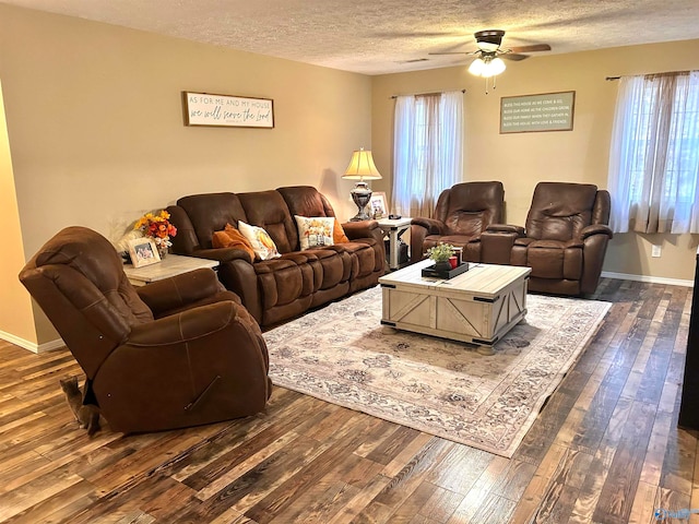 living room featuring a wealth of natural light, dark hardwood / wood-style floors, and ceiling fan