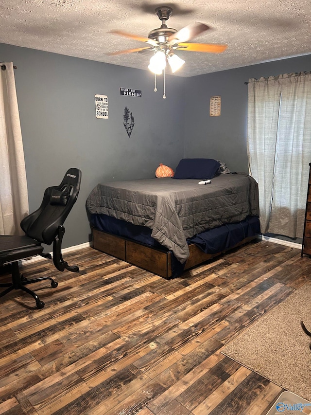 bedroom featuring ceiling fan, a textured ceiling, and dark hardwood / wood-style flooring