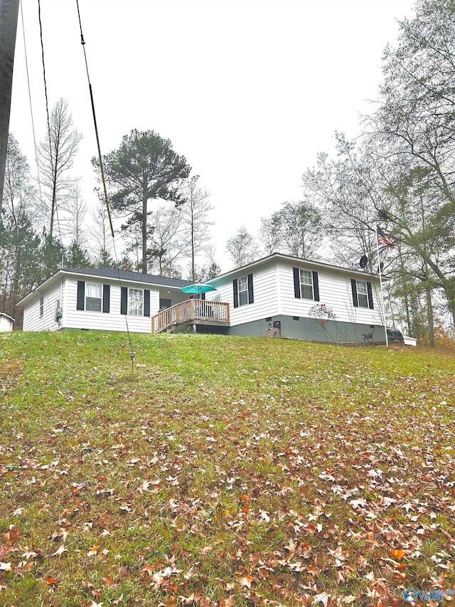 rear view of property featuring a lawn