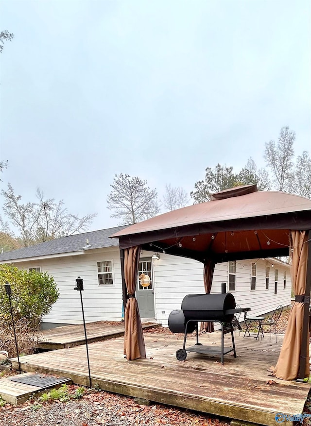 back of house with a wooden deck and a gazebo